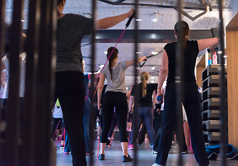 Image showing sporty women exercising with a rubber bands