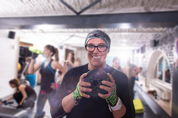 Image showing sporty woman holding a metal round weights plate