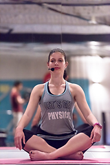 Image showing sportswoman doing yoga exercise and meditating