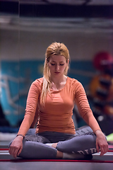 Image showing sportswoman doing yoga exercise and meditating