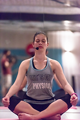 Image showing sportswoman doing yoga exercise and meditating