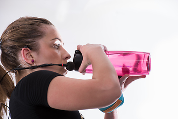 Image showing female fitness instructor drinking water from bottle