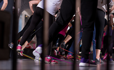 Image showing sporty women exercising with a rubber bands