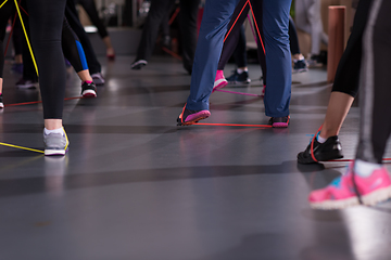 Image showing sporty women exercising with a rubber bands