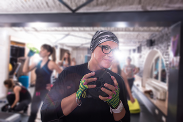 Image showing sporty woman holding a metal round weights plate