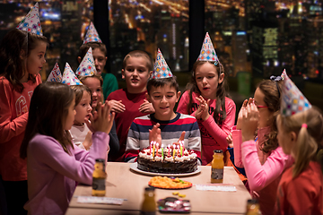 Image showing happy young boy having birthday party