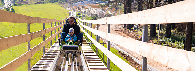 Image showing young father and son driving alpine coaster