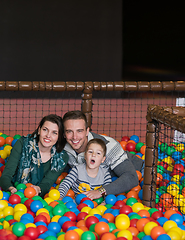 Image showing parents and kids playing in the pool with colorful balls