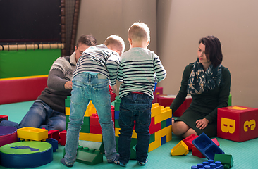 Image showing young parents and kids having fun at childrens playroom