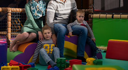 Image showing young parents and kids having fun at childrens playroom