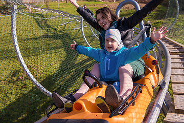 Image showing young mother and son driving alpine coaster