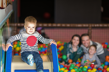 Image showing parents and kids playing in the pool with colorful balls