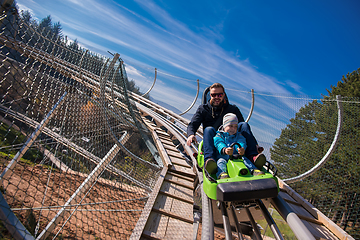 Image showing young father and son driving alpine coaster