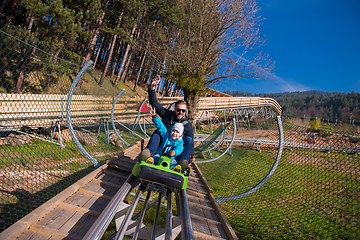 Image showing young father and son driving alpine coaster