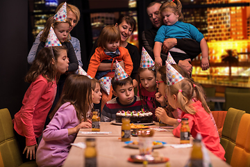 Image showing happy young boy having birthday party