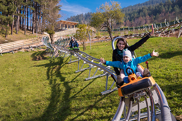 Image showing young mother and son driving alpine coaster