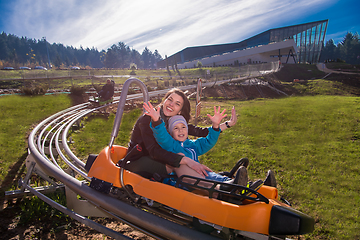 Image showing young mother and son driving alpine coaster