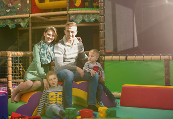 Image showing young parents and kids having fun at childrens playroom