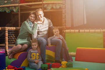 Image showing young parents and kids having fun at childrens playroom