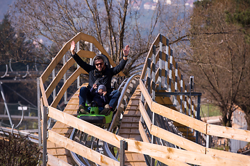 Image showing young father and son driving alpine coaster