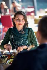 Image showing youn couple enjoying lunch at restaurant