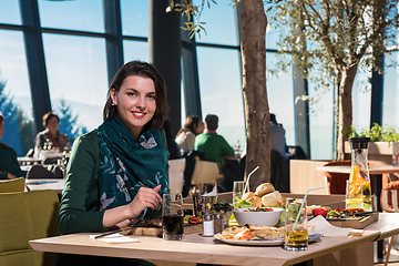 Image showing young woman  having lunch at restaurant