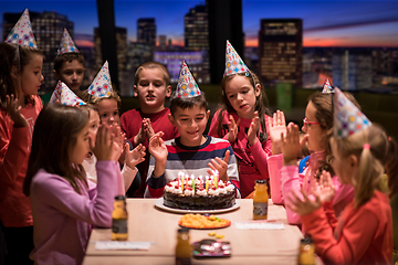 Image showing happy young boy having birthday party