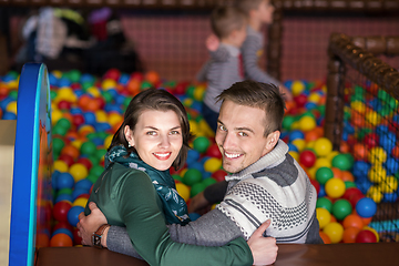 Image showing parents and kids playing in the pool with colorful balls