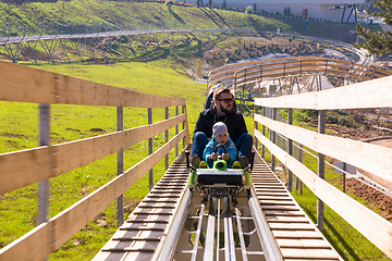 Image showing young father and son driving alpine coaster