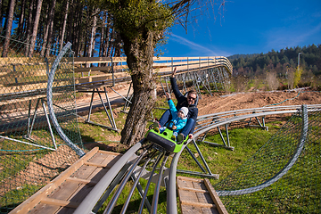 Image showing young father and son driving alpine coaster