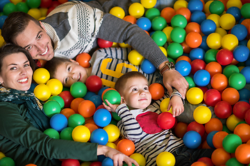 Image showing parents and kids playing in the pool with colorful balls