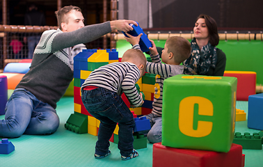 Image showing young parents and kids having fun at childrens playroom