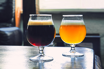 Image showing Glasses of different kinds of beer on wooden background