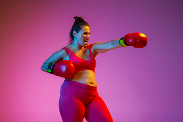 Image showing Young caucasian plus size female model\'s training on gradient background