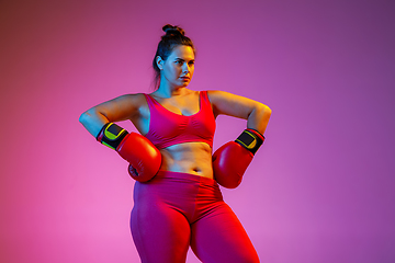 Image showing Young caucasian plus size female model\'s training on gradient background