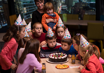 Image showing happy young boy having birthday party