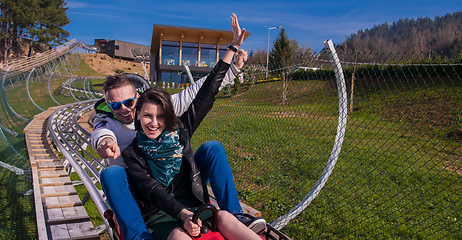 Image showing couple driving on alpine coaster