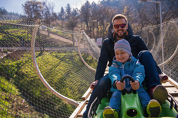 Image showing young father and son driving alpine coaster