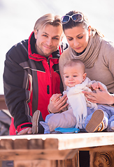 Image showing young happy family with little child enjoying winter day