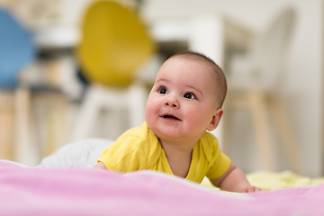 Image showing newborn baby boy playing on the floor