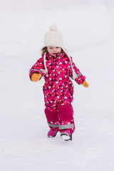 Image showing little girl having fun at snowy winter day