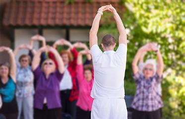 Image showing trainer training motivated active healthy senior people