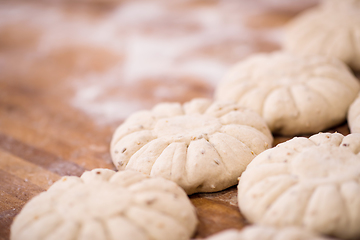 Image showing balls of dough bread getting ready to be baked