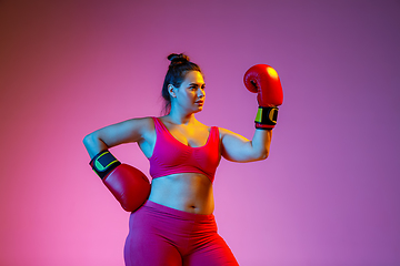 Image showing Young caucasian plus size female model\'s training on gradient background