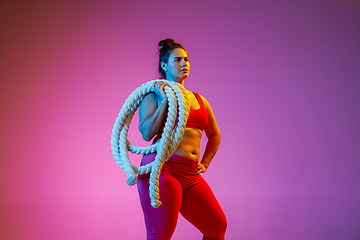 Image showing Young caucasian plus size female model\'s training on gradient background