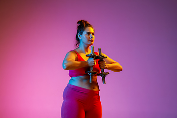 Image showing Young caucasian plus size female model\'s training on gradient background