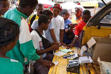 Image showing Man sell cellular phones on rural Madagascar marketplace