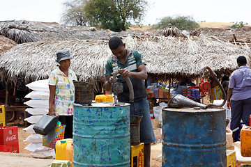 Image showing Man sell petrol on rural Madagascar marketplace