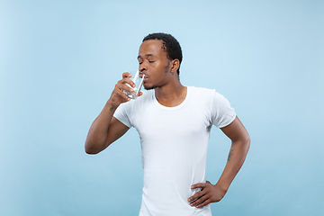 Image showing Half-length close up portrait of young man on blue background.