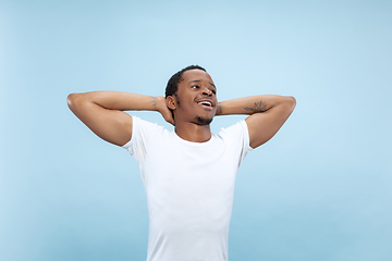 Image showing Half-length close up portrait of young man on blue background.